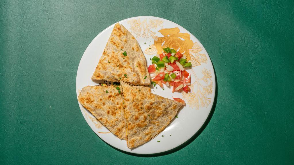 Quesadillas · Topped with melted cheese, sour cream, guacamole, pico de gallo, fried beans, a small side of wedge fries and potato chips.