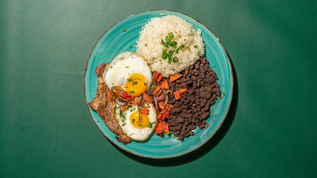 Steak And Eggs · Sirloin steak grilled and topped with eggs any style, served with white rice, beans and plantains.