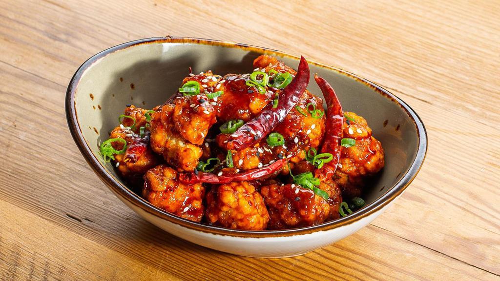 Red Hot Chili Chicken - Fried Chili Chicken · Fried chicken thigh, chili glaze, hot dried chilis, scallions, sesame seeds. 
Served with jasmine rice.
Contains: Gluten, Eggs, Soy, Fish