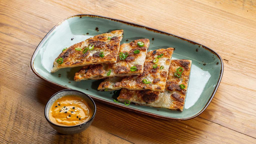 Quarter Stacks Of Scallion - Scallion Pancakes · Pan fried Chinese savory flat bread folded with scallions.
Served with yellow curry sauce.
Contains: Tree Nuts, Gluten, Eggs, Soy