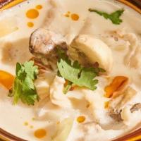 Tom Kha Chicken · Chicken coconut galangal broth, onions, mushrooms, topped with scallion, cilantro, and culan...