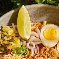 Khao Soy Chicken · Spicy. Northern Thai style egg noodles in a rich chicken curry broth, red onion, pickled mus...