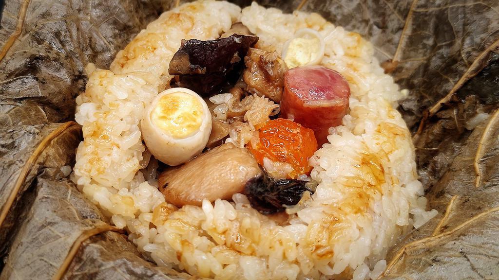 Sticky Rice Wrap · Chicken, pork, dry scallops, jicama, salty egg yolk, mushroom, dried shrimp, sausage, quail egg. One piece.