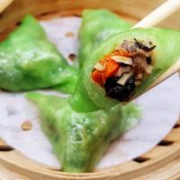 Vegetarian Dumpling · Water chestnut, bamboo shoots, carrots and enoki mushrooms. Four pieces.