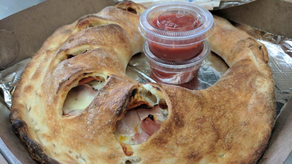 Meat Lover'S Calzone · Ham, Italian sausage, pepperoni, ricotta and mozzarella cheese. Includes 2 sides of pizza sauce.