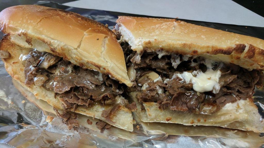 Cajun Black 'N' Blue Steak Bomber Sub · Our world famous steak topped with sauteed onions and mushrooms, bacon, bleu cheese dressing and mozzarella. 12