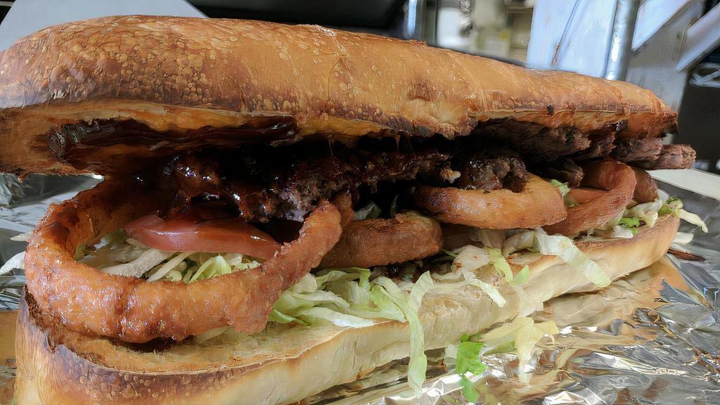 Bbq Cheddar Burger Bomber · Topped with cheddar cheese, onion rings, lettuce, tomato and BBQ sauce. 12
