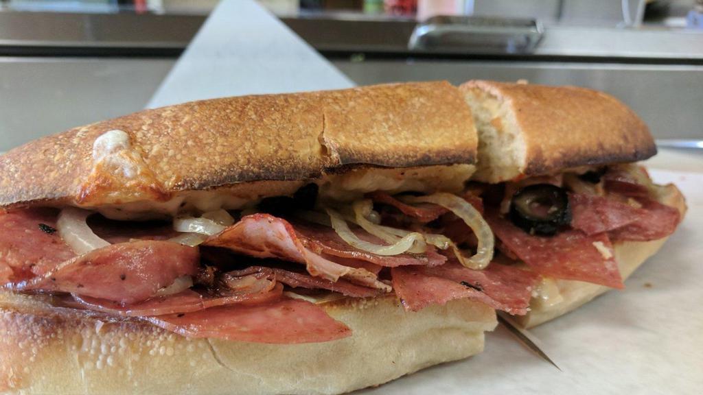 The Big Loretta Sub · Genoa salami, hot ham and provolone cheese, topped with special Italian olive salad, then baked Shoes style. 12