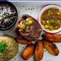 Carne Asada (Steak) · Tamarind Marinated grilled skirt steak -  served with Peruvian cilantro rice, Cuban black be...