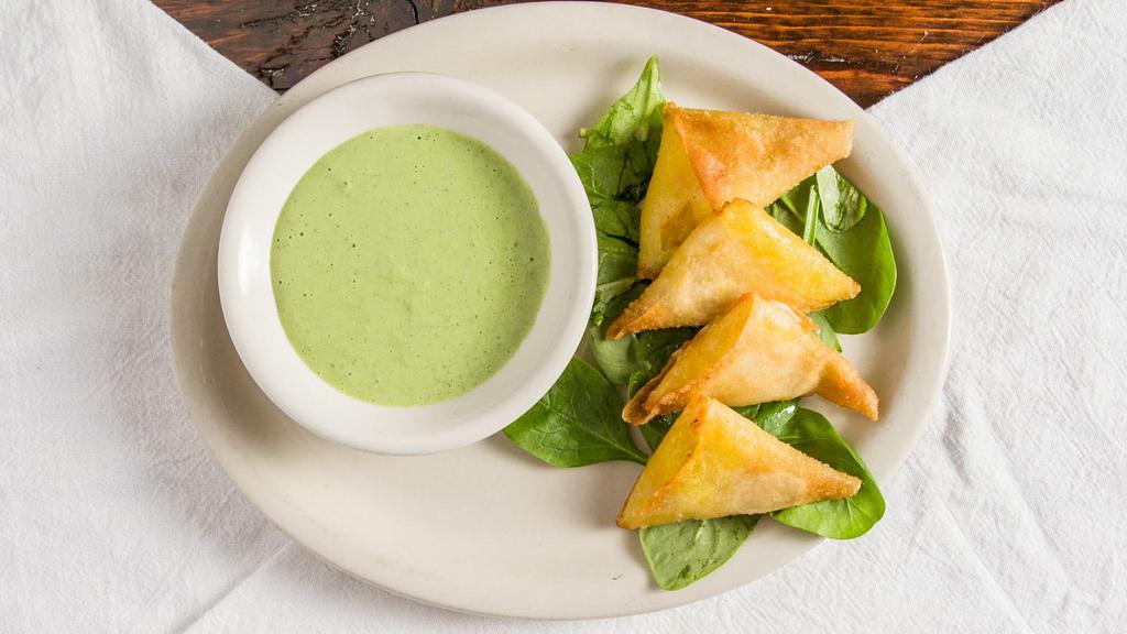 Pastels · Crispy phyllo dough filled with potatoes, herbs and spices.