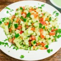 Israeli Salad · Diced tomatoes, cucumbers, peppers and parley lightly dressed with lemon and olive oil.