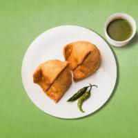 Splendid Samosa · Triangular pastry with a savory filling of spiced potatoes, peas, and lentils served with mi...