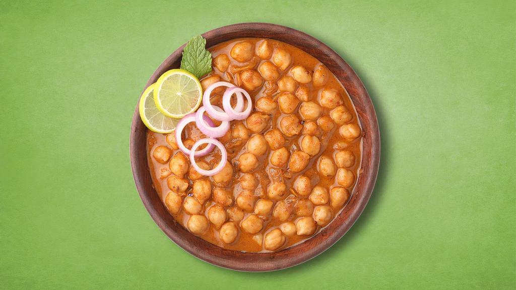 Spiced Chikpea Masala · Chickpeas soaked in water cooked in curry made with onions, juicy tomatoes and spices.