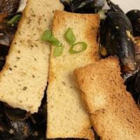 Mussels Francesca · PEI Mussels steamed in white wine, fresh garlic, Italian herbs, and a pomodoro tomato reduct...