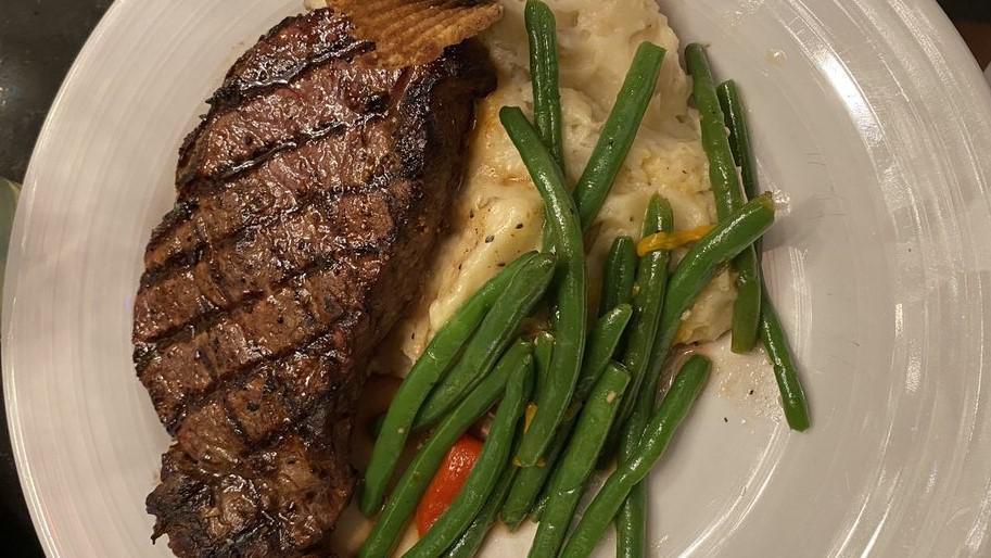 Delmonico · 16 oz bone-in Angus Reserve ribeye prepared well-marbled ,seasoned and chargrilled served with smoked gouda au gratin mash and vegetables