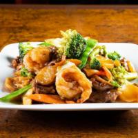 Happy Family · Sliced tenderloin of pork, beef, chicken, shrimp and scallops sautéed with vegetables in a b...