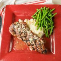 New York Strip (12 Oz) · Aged black angus beef, topped with tavern butter, and served with mashed potato and vegetable.