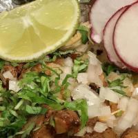 Tacos Al Pastor  · Cilantro, onions, lemon, radish and 1 Oz. hot sauce per taco.