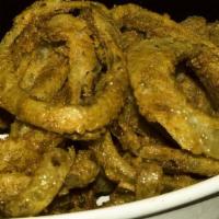 Creole Spiced Onion Rings · Hand cut onion slices marinated in cajun seasoned buttermilk, dusted in seasoned flour, frie...