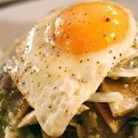 Chilaquiles Con Huevo Y Bistec · Tortillas chips with  green or red sauce with fried egg and steak.