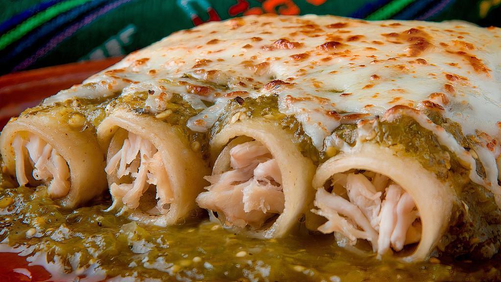 Enchiladas De Pollo · Chicken enchiladas stuffed tortilla with chicken topped with green Mexican sauce, lettuce, sour cream cheese, Mexican rice and refried beans.