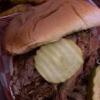 Pulled Pork Sandwich · Served on a hawaiian roll with slaw. comes with your choice of sauce and side