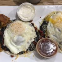 Huevos Rancheros · Two four tortillas filled with chorizo, refried black beans, Mexican three cheese, topped wi...