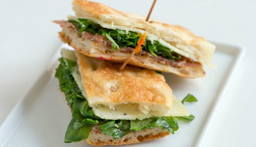 Lo Spagnolo · Jamon serrano, manchego cheese, and arugula with a quince mustard paste on pizza bianca.