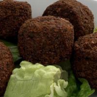 Falafel · Fried crispy mashed chickpea blended with fresh herbs. Served with tahini sauce, hummus, and...