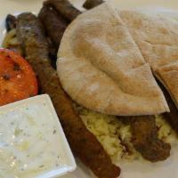 Gyro Platter · Charcoal-grilled Greek gyro served with rice, grilled vegetables, and tzatziki sauce.