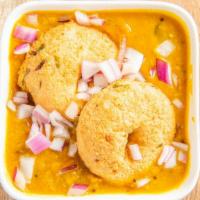 Sambar Vadai · Medhu Vadai dipped in vegetable lentil soup (sambar) and garnished with onions & coriander