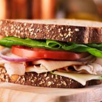 Classic Ham & Cheese Sandwich · Lean ham sandwich with Cheddar cheese, avocado, lettuce, and tomato on multigrain.
