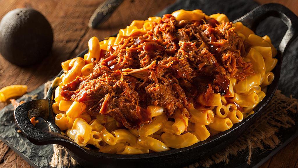 Pulled Pork Mac & Cheese · Pulled pork tossed in BBQ sauce on top of pasta noodles with homemade cheese sauce.