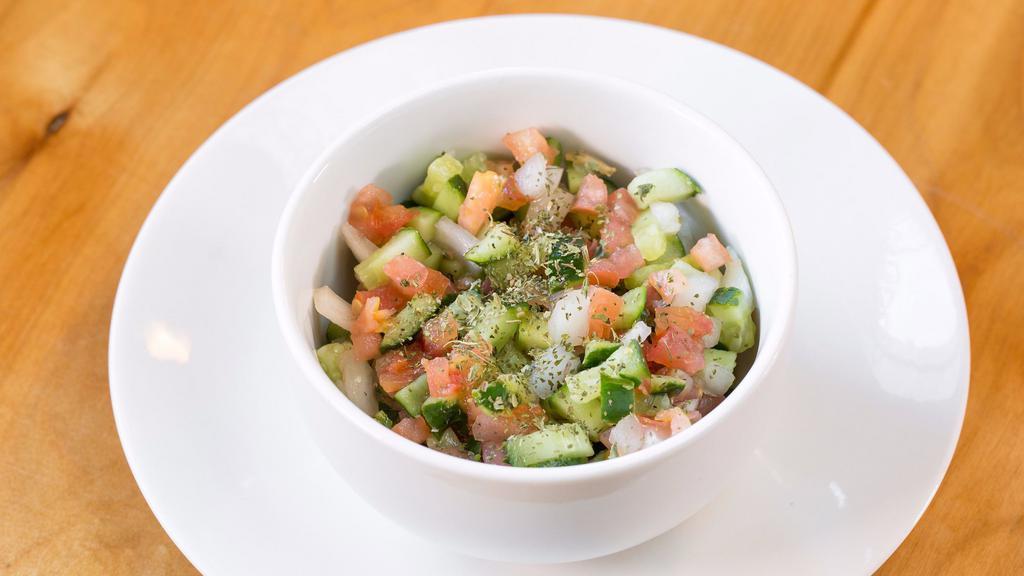 Persian Salad (Shirazi Salad) · A mixture of fresh diced cucumbers, tomatoes, onions, olive oil, fresh lime juice, and mint.