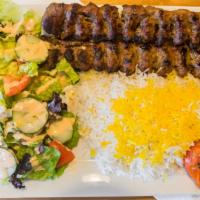 Beef Kebob (Koobideh Kebob) · Two juicy strips of grilled seasoned ground beef served with basmati rice, garden salad and ...