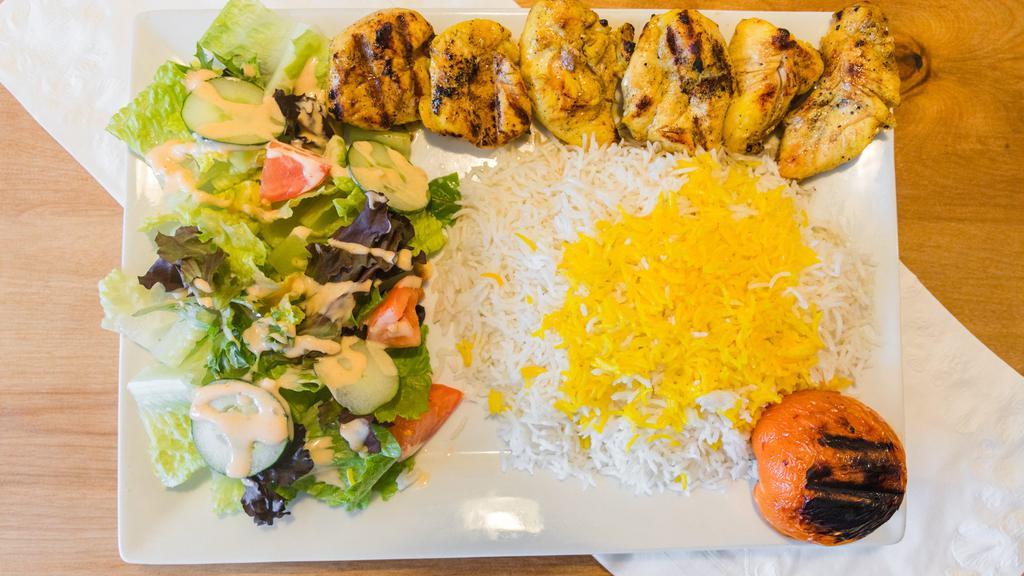 Chicken Kebob (Jujeh Kebob) · A juicy strip of grilled marinated chicken served with basmati rice, garden salad and a grilled tomato.