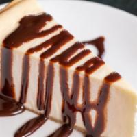 Classic Cheesecake · A creamy cheesecake topped with chocolate drizzle