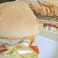 Lomito (Sirloin) Sandwich · A cut of sirloin with lettuce, tomatoes, ham, fried egg, cheese and your choice of sauce, sa...