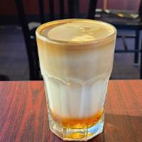 Layered Espresso · A double shot of espresso with layers of your choice of housemade syrup and milk.