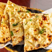 Garlic Naan · Vegetarian. Traditional white bread, flavored with garlic and baked in the tandoor.