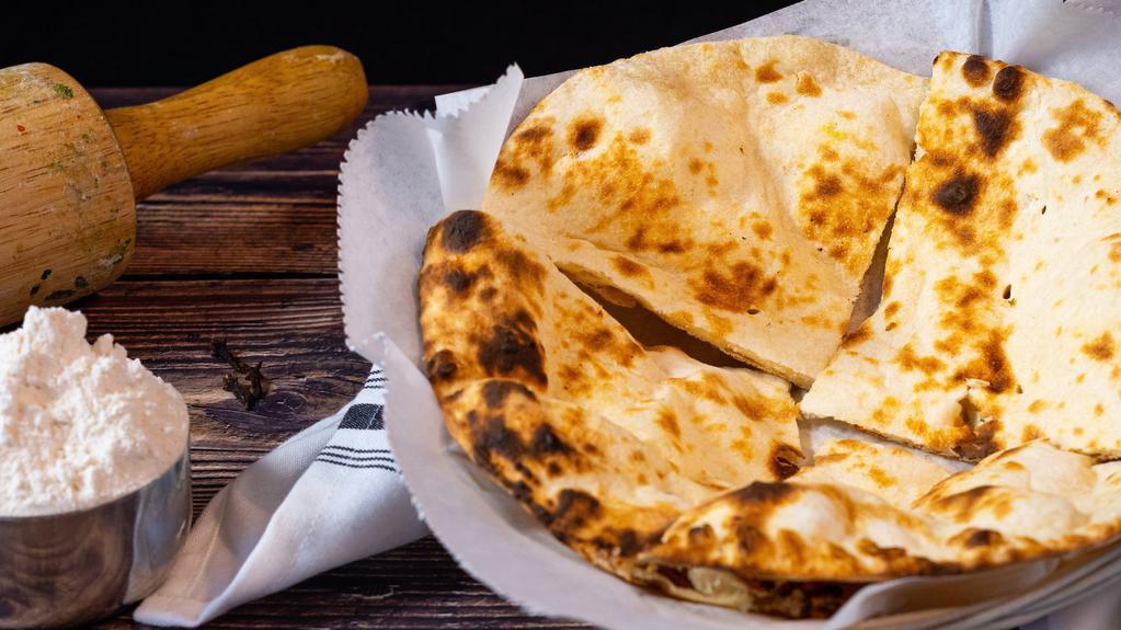 Butter Naan · Traditional white bread and baked in the tandoor.