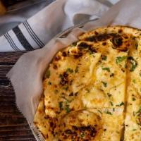 Chilli Garlic Naan (Spicy Naan) · Soft leavened flat bred made with wheat flour, garlic, and Chilli backed in tandoori clay ov...