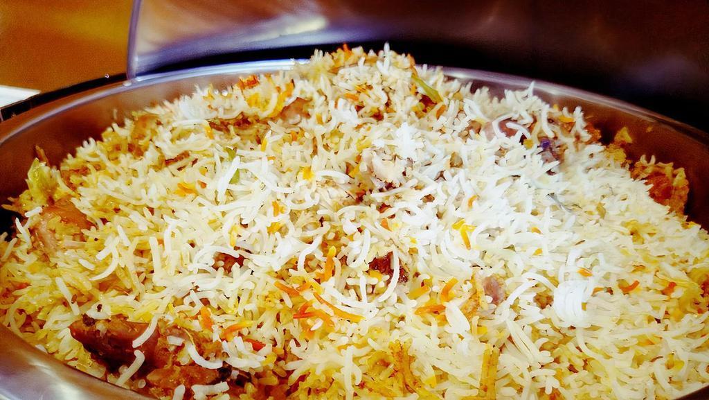 Special Chicken Biryani (Boneless) · Gluten-free.  Hot. Basmati rice cooked with tender chunks of chicken, blended with herbs and spices then garnished with egg.