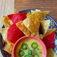 Chips Y Queso · Coconut queso, diced tomato, poblano, jalapeno served with tortilla chips