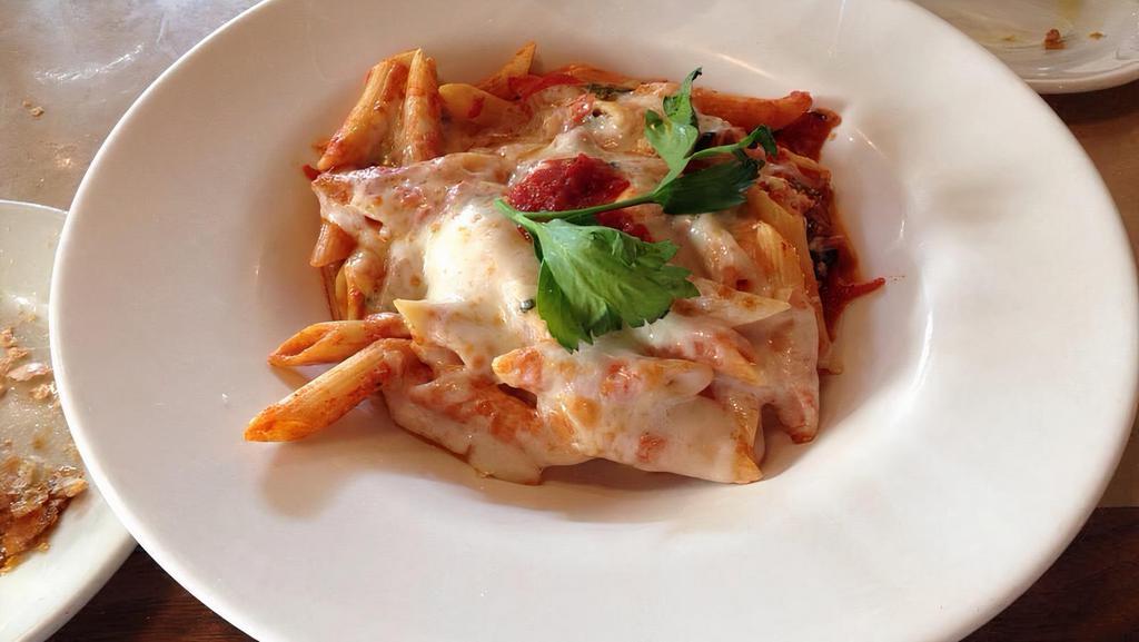 Baked Ziti Null · Served in a light tomato sauce with ricotta and topped with mozzarella cheese.