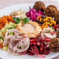 Falafa Plate Large · Gluten free, vegetarian. Six falafel balls placed on a variety of salads, finished off with ...