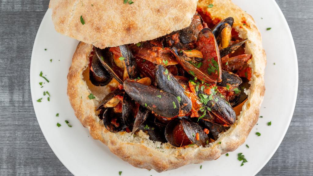Mussels Barosa · Served in a garlic white wine sauce or red tomato and garlic sauce, inside special brick oven bread.