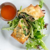 Italian Egg Roll · Egg Roll with crumbled sausage, broccoli rabe, fontina, and mozzarella cheese with side oran...