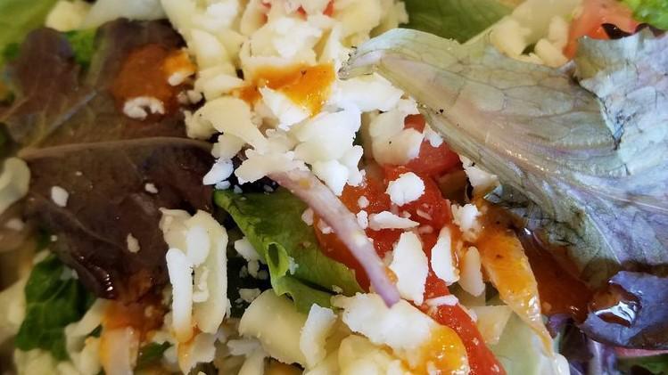 Greek Salad · Crisp romaine lettuce topped with tomatoes, cucumbers, green peppers, red onions, olives, and Feta cheese in our homemade vinaigrette dressing.