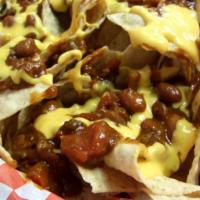 Lucy & Ricky Chili-Cheese Nachos · Tortilla chips smothered in meat and bean chili, topped with cheddar cheese, sour cream, jal...